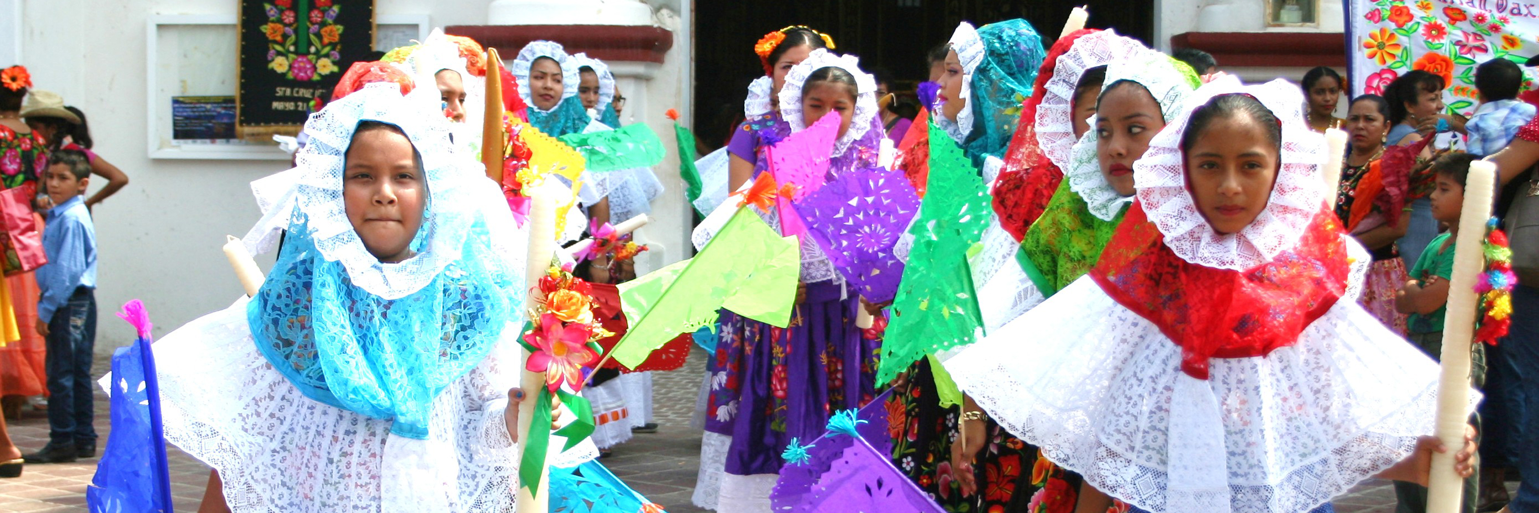 Lines of kids dressed in colorful cultural wear