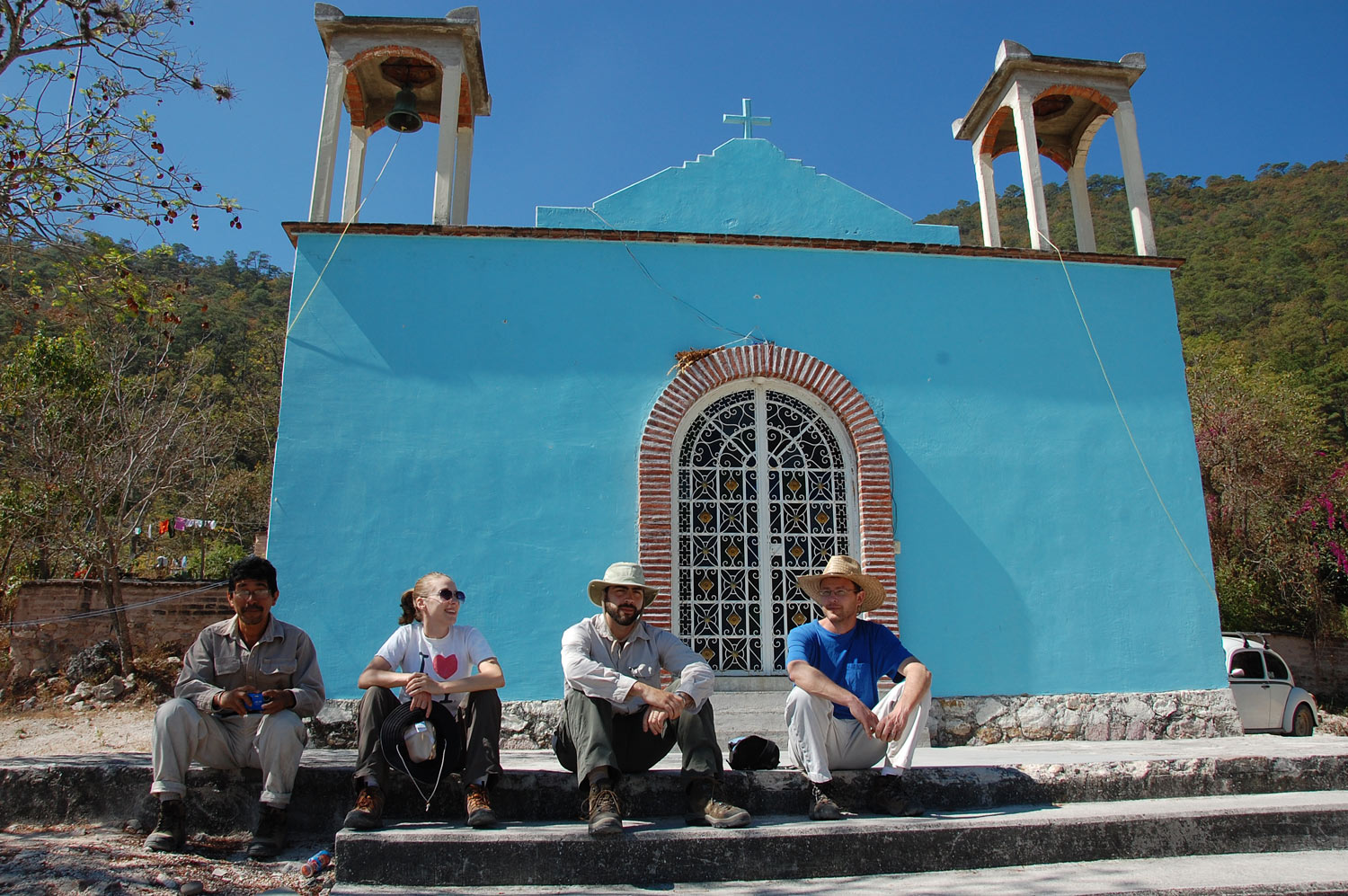 Four people sitting in front of a church