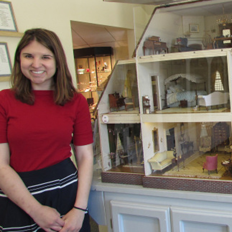 Rachel Tavaras shows off the “Yellow Georgian,” an assemblage of objects in the collections of the Museum of Miniature Houses in Carmel, Indiana.