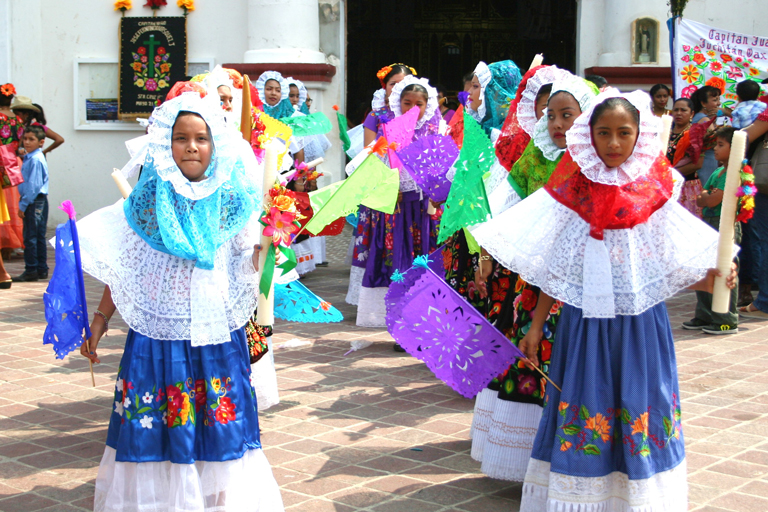 Two rows of children in colorful cultural attire