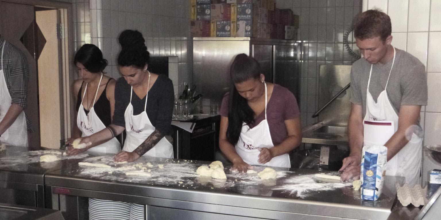 People working with dough on a table