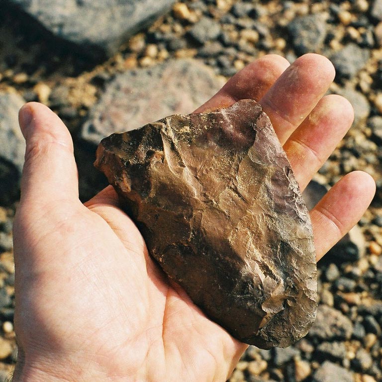 A hand holding a rock