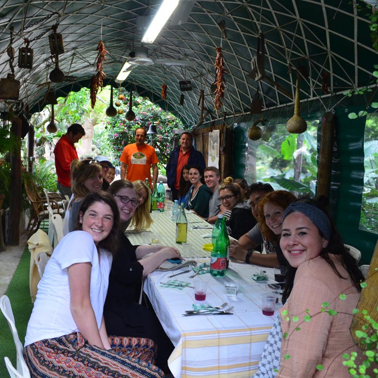 A group of people sitting around a long table
