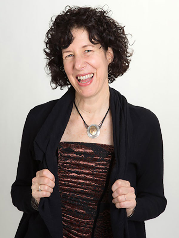 A headshot of Professor Jane Goodman, who wears a dark blazer and stands against a white background.