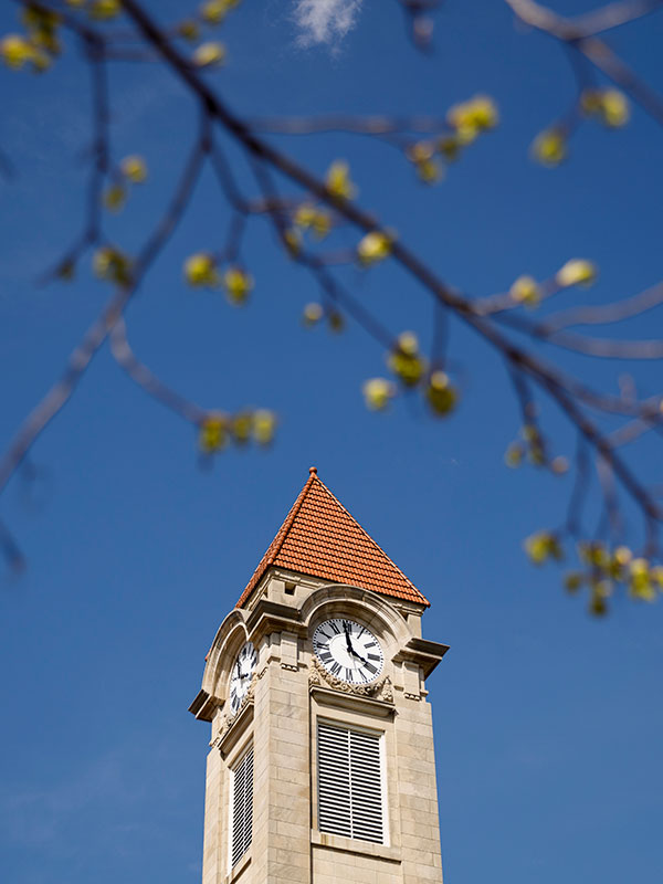 A low-angle shot of the Student Building's clock tower.