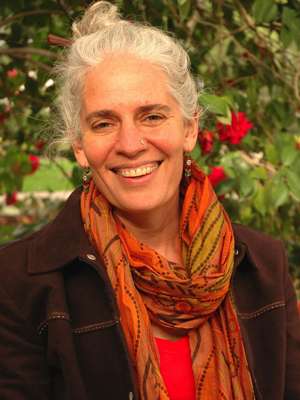 A headshot of Professor Susan Seizer, who wears a dark jacket and an orange scarf.