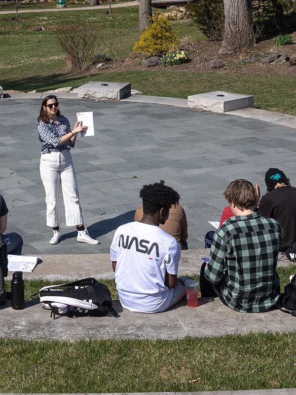 A professor lectures to students outside on IU's campus.